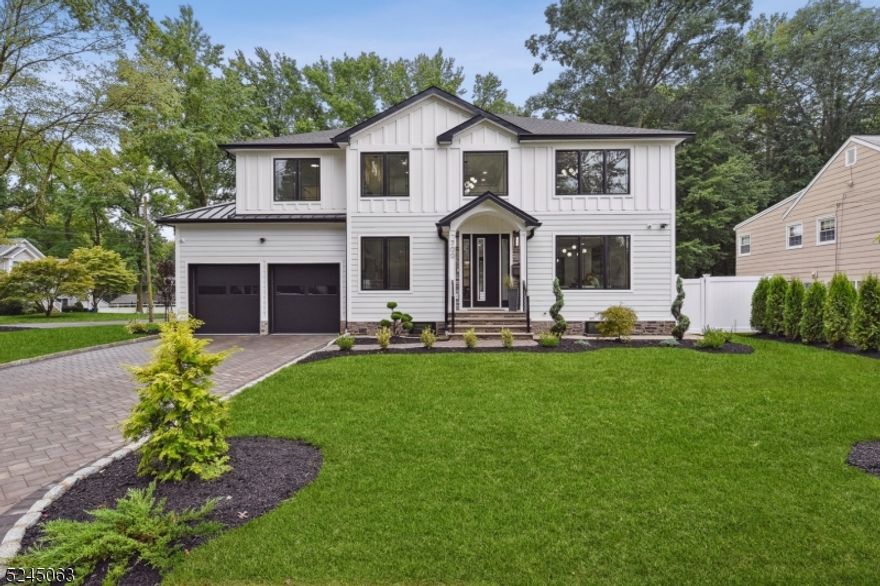 The breathtaking NEW CONSTRUCTION home is loaded with CONTEMPORARY designer features and CUSTOM finishes throughout. No expense has been spared in this masterpiece! Boasting a Chef's EIK w/Fabuwood soft-close wood cabinetry, large island w/built-in microwave and waterfall Calacatta ultra quartz counters, high-end stainless steel Dacor appliances and tile backsplash. The kitchen flows into the family room featuring a fireplace w/leather granite surround and formal dining room with wet bar and wine fridge. A guest bedroom with an ensuite bathroom (or home office), powder room and laundry room complete this level. Upstairs, you'll find four more bedrooms quietly tucked away. The primary suite includes CUSTOM WIC's and a spa-like bath with a soaking tub and stall shower. The fully finished lower level includes a recreation room with wet bar and another full bath. This AMAZING home also features high ceilings, gorgeous millwork throughout, 6' Pella windows flood the home with tons of natural light, HardiePlank siding, Timberline roof, baths w/premium tile and CUSTOM shower doors, 2-zone HVAC, tankless hot water heater, built-in indoor and outdoor speakers, NEST thermostats, oak hardwood floors throughout, Masonite solid wood doors, built-in organizers in all closets, NEWLY paved driveway, 6' vinyl privacy fence, Trex deck, paver patio, SMART thermostats and garage doors, Generac whole house generator & much more! Conveniently located to top-rated schools, parks, shops & NYC train.