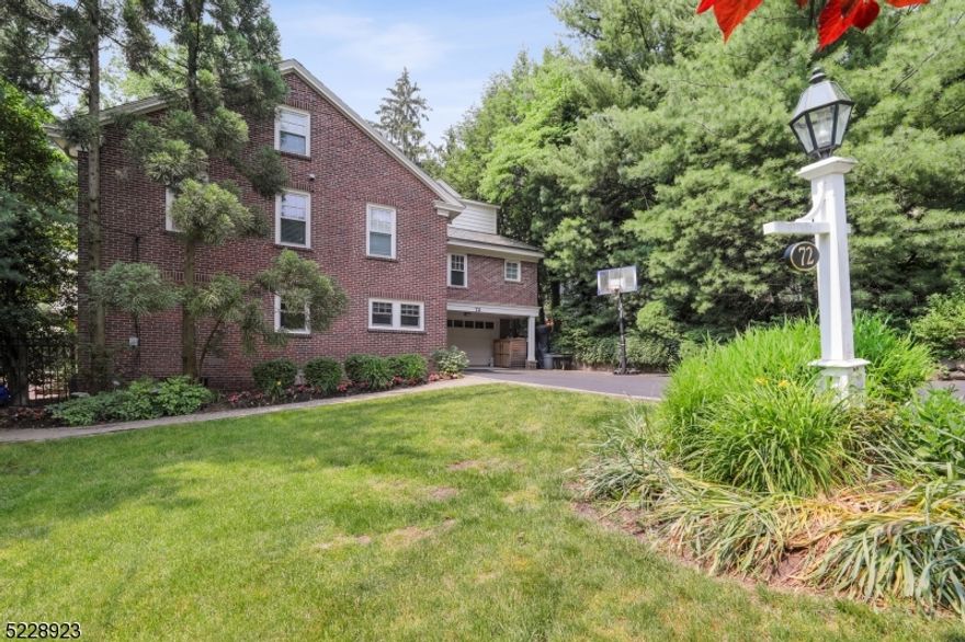 Very special brick and clapboard 1920's English Colonial, retaining its original charm and architectural detail. Special features include living room with wood burning fireplace, built ins, hardwood flooring adjacent to office/den with wall of windows, screened in porch with beautiful views. Eat-in kitchen with Granite countertops, wood cabinetry, breakfast bar and large dining area.  Second floor includes spacious primary suite with fitted closet, full bath with jetted tub plus 3 additional bedrooms and 2 full baths. Spectacular third floor family room with cathedral ceiling and door leading to private deck, bedroom #5 and full bath, office/study with built in wet bar. Situated on gorgeous grounds with deluxe hot tub surrounded by many new plantings...great for outdoor entertaining!  Close to town, NYC Midtown direct train, and top-rated Millburn schools