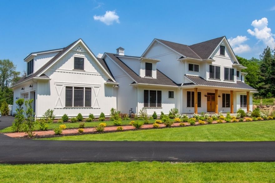 New build with a REVISED FIRST LEVEL FLOORPLAN THAT INCLUDES A FORMAL LIVING ROOM & DINING ROOM! A one-of-a-kind contemporary farmhouse-style home on a scenic 7 acre lot at the end of a private winding road. Understated luxury for a relaxed lifestyle! This masterpiece is surrounded by lovely homes including the recent McCann built estate home anchoring Village Road. Open skies and sunset views from the front rocking chair porch grace this peaceful setting. A walking path takes you through nature in the rear of the property. A back porch with hanging lanterns overlooks the spacious, lush yard which includes a beautiful heated in-ground swimming pool.The interior space is open yet warm and is appointed with substantial millwork including ship-lap and distressed wood beams. The kitchen is stunning with high-end luxury appliances,farmhouse sink, quartz center island, Viking range and oversized wood hood. The home features view-rail stair system and double-height family room with magnificent views of both the interior and exterior living spaces. This 9000sf home features a luxurious first-floor primary suite with linear fireplace. The additional bedrooms have beautifully appointed en-suite baths. The lower level is fully-finished with wine/tasting cellar, movie theater, playroom, sitting room & fitness room with rubber flooring and full wall of mirrors.This estate home is a completely turn-key luxury farmhouse. Minutes to shopping, NYC train, restaurants and award-winning schools.