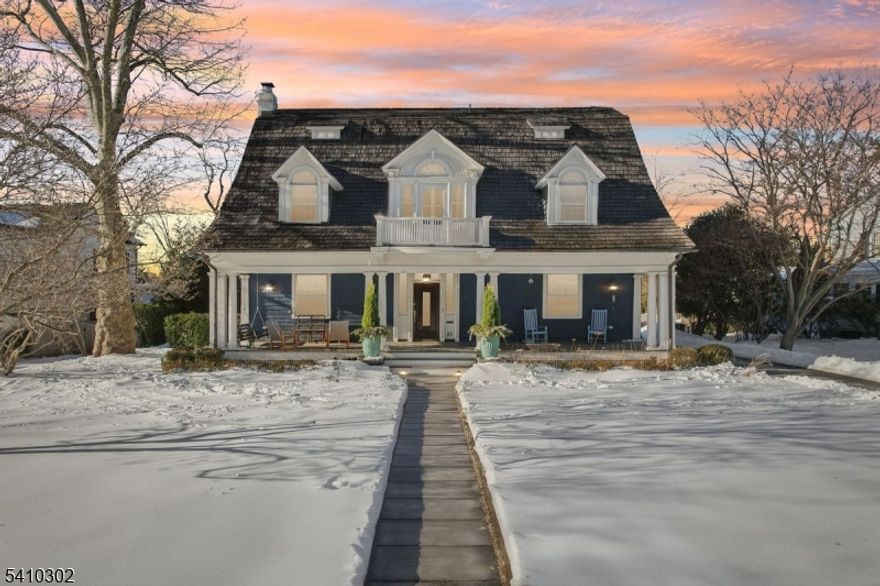 This beautifully renovated early twentieth century Dutch Colonial Revival home blends historic charm with modern living in sought after Stoneleigh Park, just moments from downtown Westfield, top rated schools, and the NYC train. Thoughtfully redesigned by the award winning team at AHD & Co., the residence balances architectural integrity with contemporary comfort. The project received the AIA Bronze Award in Historic Preservation.The light filled kitchen and dining area create an open, inviting hub for everyday living and entertaining, enhanced by a new scullery for added storage and function. Warm white cabinetry, classic subway tile, and a marble topped island anchor the space. The living and family rooms offer refined yet comfortable gathering areas with abundant natural light and strong indoor outdoor connection. A wood burning fireplace warms the living room, while a cast stone gas fireplace highlights the family room.The home offers five bedrooms, four full baths, and one half bath, including a private primary suite with radiant heated marble floors, walnut cabinetry, and a soaking tub. Updated hall baths serve the upper levels.Outdoor spaces feel like a private resort with a saltwater pool, cabana, mature landscaping, and blooming hydrangeas. Stoneleigh Park is prized for its winding streets, park like setting, and architectural heritage, making this a rare and special offering.