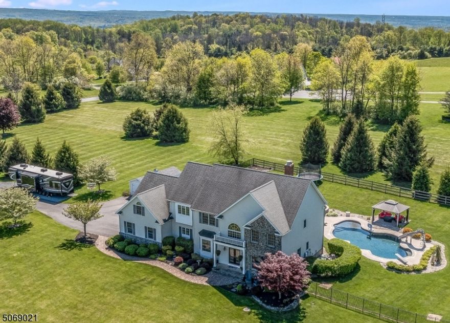 A SUPERBLY MAINTAINED 4BBR & 3 FULL BATH 3800 SQ FT COLONIAL WITH A RECENTLY UPGRADED KITCHEN ON A GORGEOUSLY LANDSCAPED 3.33 ACRE LOT COMPLETE WITH A TRULY EXTRAORDINARY RESORT-CALIBER POOL COMPLEX  AND A GREAT HOLLAND TOWNSHIP LOCATION JUST 12 MINUTES FROM RT 78 IN A LOVELY NEIGHBORHOOD SETTING OF COMPARABLE HOMES. YOU'LL ENJOY SPECTACULAR 180-DEGREE SUNSET VIEWS FROM BOTH THE HOUSE ITSELF AND THE RESORT-LIKE POOL SITE WHICH OFFERS A NEW CUSTOM-DESIGNED POOL COMPLEX WITH AN OUTDOOR KITCHEN, AN ENORMOUS WRAP-AROUND PAVER PATIO, & A LARGE SHADE-PROVIDING GAZEBO WITH GREAT UNOBSTRUCTED SUNSET VIEWS. THE HOME ALSO FEATURES A GREAT OPEN FLOOR PLAN WITH A RECENTLY UPGRADED GRANITE & STAINLESS STEEL CENTER ISLE KITCHEN, AND AN EXPANSIVE 2-STORY FAM RM WITH A FULL  WALL OF WINDOWS & A FLOOR-TO-CEILING BRICK FIREPLACE. OTHER HIGHLIGHTS INCLUDE A HUGE FULLY-WINDOWED CATHEDRAL CEILING MBR SUITE WITH 2 LARGE WALK-INS & A PRIVATE SITTING RM, A LUXURIOUSLY UPGRADED MASTER BATH, SPACIOUS SECONDARY BEDROOMS, HARDWOOD FLOORS, NEW CARPETING, A 75,000 BTU WOOD STOVE INSERT, A WHOLE-HOUSE GENERATOR, TECHNO-BLOCK WALKWAYS, AND MUCH MORE!