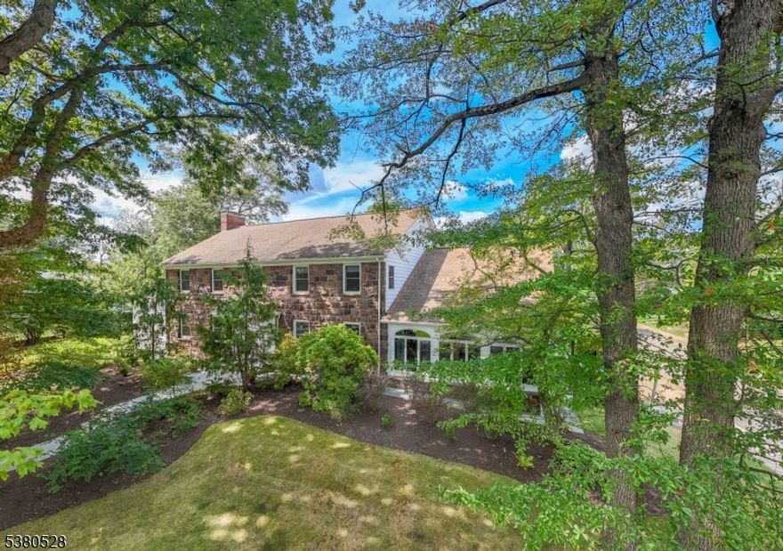 STATELY 5,500 SF CENTER HALL COLONIAL IN DESIRABLE NEWSTEAD SECTION NEIGHBORHOOD OFFERS SPACE, LIGHT & INFINITE POTENTIAL TO CALL YOUR OWN! Nestled in an established tree & sidewalk-lined neighborhood bordering scenic South Mountain Reservation, 61 Crest Drive exudes timeless charm updated for modern-day living. Gleaming hardwood floors stretch throughout the First & Second Levels, highlighted by period molding, bright French doors & maintenance-free updated windows offering expansive views of large, level corner property with bluestone terraces & walkways, mature privacy hedges & plenty of room for a future pool. Three wood-burning fireplaces make for cozy moments in the Den & Living Room. Enclosed Sun Room off Dining Room is the perfect spot to relax after a meal. Eat-in Kitchen is warm & inviting with cherry wood cabinets, professional SS appliances (Sub-Zero, Viking, Jenn Air, Bosch), peninsula, island with prep sink & a breakfast nook! Private wing off Kitchen offers 2 convenient Bedrooms with shared Full Bath featuring clawfoot tub/shower. Expansive Second Level features 4 more Bedrooms, tons of closet space, 3 full Bathrooms & option for dressing room, study, office or playroom. Third Level offers even more space with a finished room & attic storage. Lower Level is a showstopper with Bar Room/Office, Family Room with third fireplace & attached Full Bath, Large Recreation Room, Laundry & access to 2-car Attached Garage. This is a home for generations!