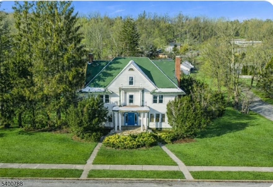 MAJESTIC FIXER UPPER! In this picture perfect downtown rich with community and culture sits this GRAND Colonial that offers a rare opportunity to RESTORE it to its former glory. Brimming with character and architectural charm, the expansive floor plan features generously sized rooms, beautiful fireplaces, and timeless details that invite a full reimagining.As soon as you walk in you can  envision the elegant gatherings this home once hosted. The entry opens to an impressive formal living room with a grand fireplace into a bright, sun-filled den at the rear. To the left, a stately formal dining room showcases its own fireplace, ideal for entertaining on a grand scale. The oversized kitchen includes custom cabinetry and is complemented by a breakfast room and additional seating area beyond, offering ample space for a future redesign.The second floor features three spacious bedrooms, a large main bath, and a sizable laundry area. The third floor offers two additional bedrooms, a full bath, and a large walk-in storage area with flexible potential.The basement is substantial in scale and includes its own bathroom with shower, offering additional space that could have many uses.THIS PROPERTY REQUIRES SIGNIFICANT RENOVATION AND IS BEING SOLD STRICTLY AS IS. PLEASE  USE CAUTION WHEN SHOWING. BEST AND FINAL WED JAN 14 1:00PM