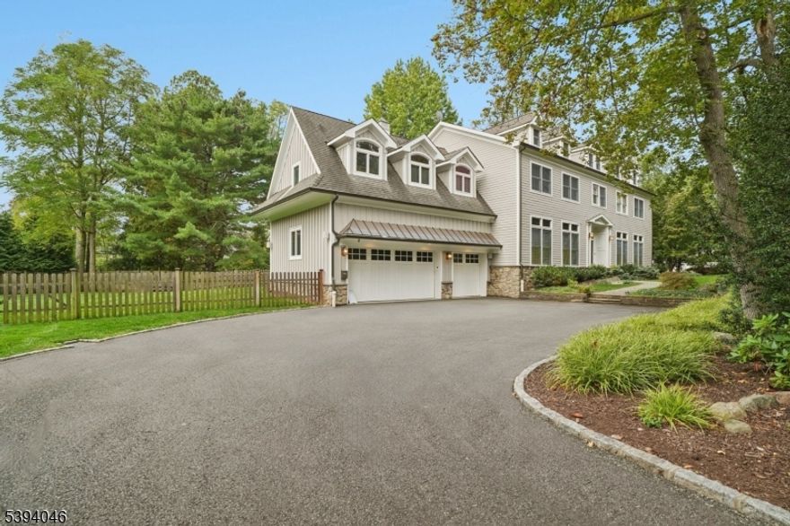 STUNNING COLONIAL * AMAZING DEERFIELD LOCATION * This modern Short Hills Colonial blends timeless elegance with contemporary "new-construction" luxury, featuring high ceilings, designer finishes and an effortless, open floor plan. Enter the stately double front doors and the grand two-story foyer with signature staircase welcomes you in. There is a sun-filled living room w/ a gas fireplace & custom built-in desk and, across the hall, a banquet-sized dining room w/ plantation shutters and exquisite architectural details. Gourmet kitchen features a lg center island, high-end appliances & a butler's pantry w/ wet bar & wine fridge. The kitchen opens to a breakfast area & family room w/ custom built-in bookshelves, gas fireplace & French doors to the patio. 1st flr powder room and mudroom lead to oversized, 3-car garage w/ EV charger. Upstairs: the primary suite offers a gas fireplace, large custom walk-in closet & spa-like bath with double vanities, soaking tub & glass shower. There is a guest bedroom suite with attached full bath that offers guests a private retreat. Three additional bedrooms, renovated hall bath & 2nd flr laundry add convenience. Finished LL: rec rm, fab exercise area, game room, full bath & kitchenette. Outside: beautifully landscaped, fully fenced yard with mature trees provides privacy. Located near South Mountain Reservation, Greenwood Gardens downtown Millburn & top-rated schools. Easy commute to NYC. Elegant, modern & move-in ready!