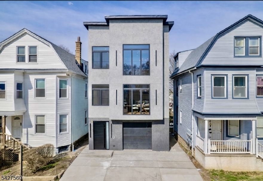 A statement of sophistication and craftsmanship, this custom new-construction two-family residence redefines modern living in Irvington, NJ. Designed with an emphasis on natural light, open flow, and contemporary elegance, every element of this home exudes refinement. From the 9-foot ceilings and gleaming hardwood floors to the European windows and designer tile-work, each detail has been curated for comfort and style. The chef's kitchen showcases quartz countertops, premium stainless-steel appliances, and a stunning center island perfect for entertaining. Step into the primary suite complete with a walk-in closet and spa-inspired bath. The versatile lower level provides ample additional living space, ideally for recreational room, media room, yoga room the options are endless, additional half bath, laundry, and access to an oversized garage. All this at a value that is truly unmatched in today's market. Incredibly low taxes and 5 year benefits apply. Conveniently located close to parks, shops, eateries, NYC commute, & so much MORE!