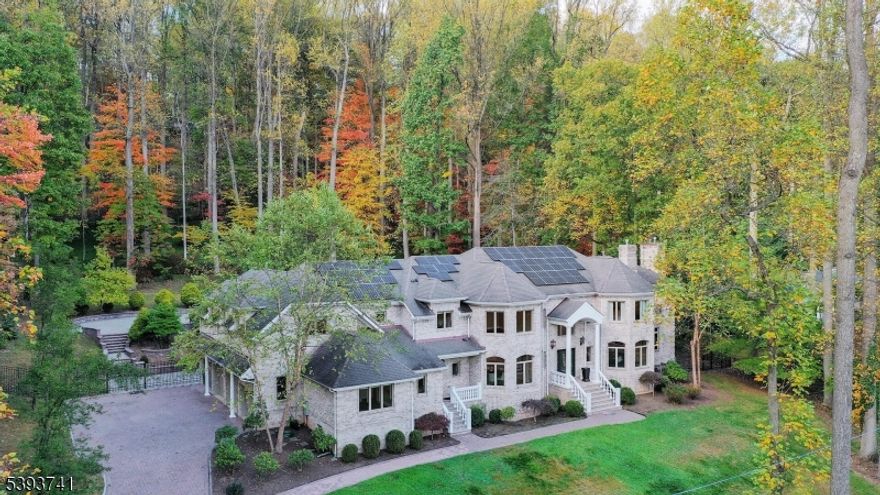 Elegant and timeless, this stately 16-room Watchung estate welcomes you with brick pillars, stone walls, and classic carriage lamps leading to a grand residence built with perfection in mind. Exceptional architectural design blends seamlessly with exquisite craftsmanship throughout, featuring Brazilian cherry floors, intricate multi-piece moldings, tray ceilings, and custom inlays that showcase remarkable attention to detail.The gourmet kitchen is a true centerpiece, boasting rich cherry cabinetry with intricate trim, gleaming granite countertops, imported Turkish marble tile, and top-of-the-line appliances, including a Sub-Zero refrigerator, ideal for both everyday living and entertaining. The home's gracious layout includes a dramatic two-story family room filled with natural light, a stunning butterfly staircase in the foyer, and multiple inviting paver patios that extend the living space outdoors.The luxurious primary suite is a private retreat, featuring a vaulted ceiling, a cozy fireplace sitting room, an expansive dressing area, and a spa-like bath designed for relaxation. Each of the six spacious bedrooms offers its own en suite bath. Set on a private and beautifully landscaped property, this residence combines elegance, sophistication, and superior quality in every detail. No expense was spared in crafting this extraordinary home that perfectly balances grandeur and warmth, truly a masterpiece of refined living.