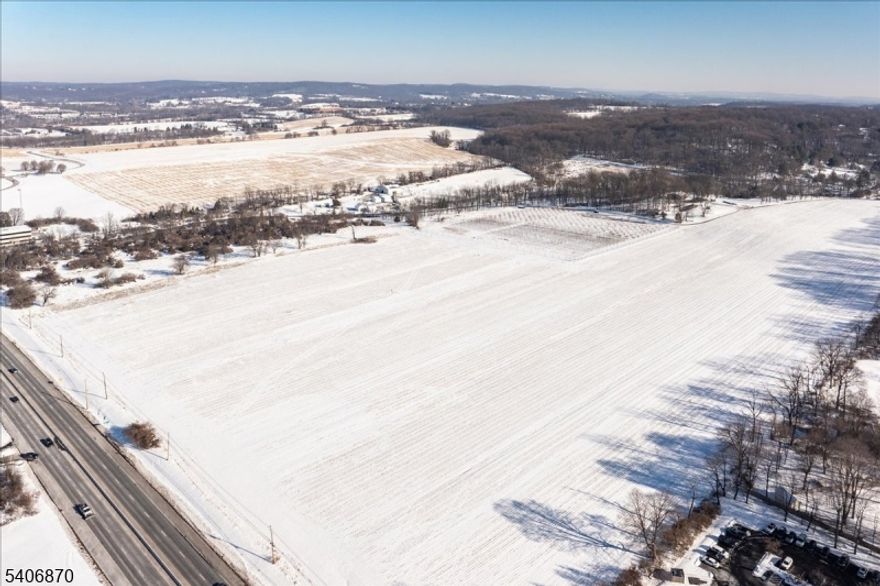 An exceptional 40-acre offering in the heart of Hunterdon County, this property presents a rare opportunity to acquire a substantial tract of land with extraordinary frontage and long-term potential. Positioned at the southeast corner of Route 31 and Valley Crest Road, the site offers approximately 1,769 feet of frontage along Route 31 and an additional 910 feet along Valley Crest Road, providing excellent visibility and access along a major north-south corridor. The land features generally level to gently rising topography, suitable for a variety of future uses. Approximately 26 acres are in productive agricultural use, complemented by 14 acres of wooded and undeveloped land that enhance privacy and natural character. The property is farmland assessed, offering favorable carrying costs while in agricultural use. Zoned ROM-1 (Research, Office & Manufacturing), the parcel permits a wide range of uses, including research and laboratory facilities, professional offices, conference centers, light manufacturing, municipal uses, and continued agricultural operations. Located within the Highlands Planning Area "Existing Community Zone," the property offers proximity to regional employment centers while preserving the pastoral character Hunterdon County is known for. Whether envisioned as a long-term investment, build-to-suit opportunity, or continuation of its agricultural legacy, this offering combines scale, frontage, zoning flexibility, and access.