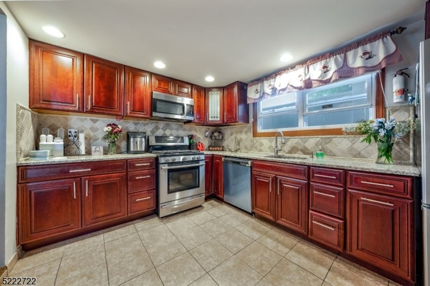 Welcome to this charming ranch-style house nestled in the heart of Hillside. This meticulously renovated home offers a comfortable and modern living space. Step inside and be greeted by a warm and inviting atmosphere. The main level of the house boasts five well-appointed rooms, including three spacious bedrooms. Each bedroom offers ample natural light, providing a cozy and tranquil retreat. The recently renovated full bathroom features contemporary fixtures and finishes, ensuring a stylish and functional space for your daily routines. One of the highlights of this property is the finished walk-out basement. This versatile space provides additional living area and can be transformed into a home office, media room, or a recreational space to suit your needs with a full laundry room. Totally renovated kitchen with SS appliances including a brand new dishwasher. This beautiful property offers direct access to the outdoors, with a great fenced in front yard with Cambridge pavers and a private patio in the back,  allowing you to enjoy the fresh air and take in the beautiful surroundings. Outside, a driveway provides convenient parking, eliminating the hassle of searching for parking spaces. The property is situated in a serene neighborhood, offering a peaceful ambiance and a sense of community. With its prime location in Hillside, this renovated ranch-style house combines modern comfort with suburban charm. Don't miss the opportunity to make this delightful property your new home.