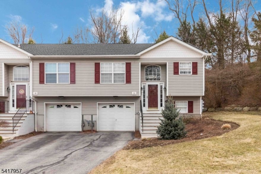 Private end unit townhome facing the woods with garage!  This fabulous two level home is located in a quiet and convenient area of Hamburg! Minutes to Crystal Springs, Mountain Creek, Minerals Sports Club, all commuting routes, shopping, restaurants, and area amenities. The ground floor features a cozy family room highlighted by a gas fireplace, full bath, laundry room, and access to the one-car garage. The first floor offers an easy-flowing main living area, an open-concept kitchen with granite countertops and stainless steel appliances, a spacious dining room, a living room with sliders to the deck, two bedrooms, and a full bath with a relaxing jet tub. Beautifully finished home with neutral colors, generous room sizes, amazing storage, hardwood flooring in the dining room and living room, custom blinds and an abundance of natural light.  1 car garage plus 2 parking spots.  Schedule your private tour before it's too late!