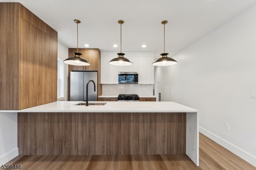 Stop scrolling! The "rental gods" have smiled upon you with 84 Hollywood Avenue, Unit 1. This brand-new 2025 construction feels like it was designed by someone who actually listened when people said, "I just want space.  The walk-in closets are so large that you may briefly forget which room you came from. The main level has bright finishes, brand-new stainless steel appliances, and an in-unit washer and dryer so you can retire from the laundromat circuit forever. The lower level opens into an enormous studio space that can transform into whatever your imagination allows: workspace, hobby space, peaceful bunker, or the repository for all the items you swear you'll organize someday. Parking is no joke either, with a private garage built to house two full vehicles. Outside, the backyard stretches wide, encouraging spontaneous lounging. With quick access to the Parkway, 280, NJ Transit buses, a nearby gym, and local places of worship, Unit 1 makes saying "yes" surprisingly easy.