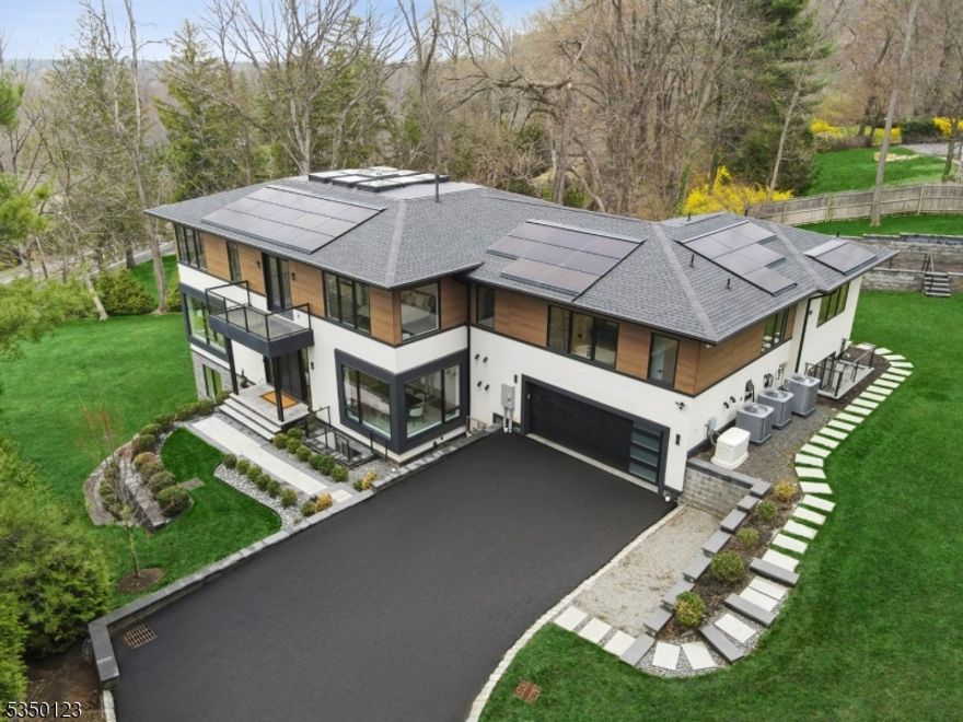 Welcome to this truly exceptional CUSTOM contemporary home, thoughtfully crafted for luxury and modern living. This striking residence features 6 bedrooms, 5 of them with their own private ensuite bath. A one-of-a-kind central skylight floods the interior with natural light, creating a bright and airy ambiance. The first floor flows seamlessly with a sleek contemporary kitchen that opens to expansive living and dining areas ideal for everyday living and entertaining. Upstairs, the expansive primary suite is a private retreat with a vanity room, personal wet bar, impressive walk-in closet, and a spa-inspired bath featuring a soaking tub, double shower heads, and a rainfall shower. A thoughtfully designed study with stunning outdoor views and a convenient laundry room complete the upper level. The ground level walkout is built for pure enjoyment with a massive recreation room, gym, home theater space, wet bar, and a space pre-wired for a wine cellar. The multi-tiered backyard features a Techo-Bloc patio that's covered by the expansive. This area of the patio has gas and water lines and is ready for an outdoor kitchen. Additional highlights include 10-ft ceilings, top-of-the-line stainless steel appliances, floating custom staircase, Enphase solar panels, Lutron smart switches, 24kw Generac whole-house generator, EV charger, 12-zone app-controlled sprinkler system, landscape speakers and much, much more! No expense has been spared in this masterpiece of a home. It's a must-see!