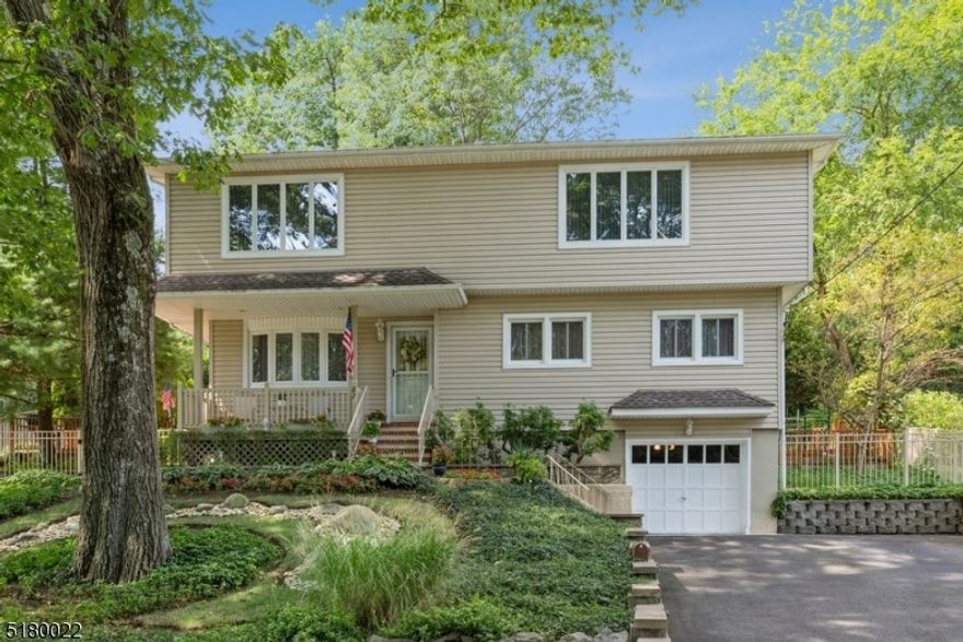 Spacious, private backyard, convenient location! Beautifully kept Colonial offers 4BD, 2BTH, an attached one-car garage, and a fabulous backyard deck. This exceptional home sits on a manicured lot in Bloomingdale, close to schools, shopping, dining, parks, and Routes 287 and 23. Full of charm and character this wonderful mid-century home presents hardwood and tile floors, large rooms with lots of natural light, and great entertaining spaces inside and out. From the welcoming front porch, step inside to a beautiful floating staircase in the foyer defining the open design living and dining areas. The bright, sunny kitchen includes a breakfast nook with a granite topped table for morning coffee or afternoon snacks. Sliding glass doors open to a sprawling multi-level deck that spans the entire width of the house, offering several seating, lounging, and additional storage spaces all overlooking the manicured back lawn "the perfect setting for warm weather entertaining. A bedroom and a full bathroom complete the main level. Upstairs is the lavish primary bedroom complete with a sitting area and sliding glass doors to a cozy balcony looking out on the private back yard. There are two additional large bedrooms and a dazzling tile bathroom updated with a luxurious, jetted corner tub and a bidet.  Even more living space has been created in the finished basement offering a large recreation room, a separate sitting area with a wood-burning stove, a laundry room, and access to the garage.