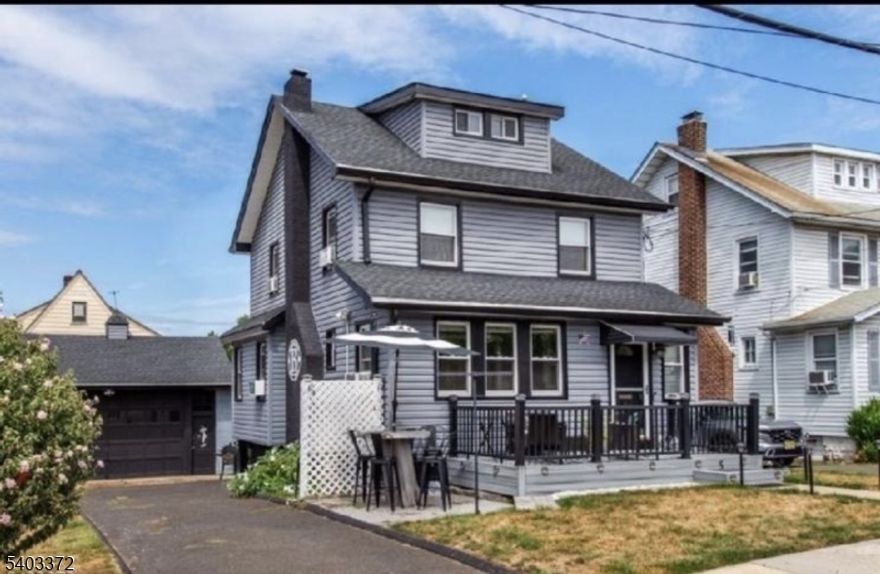 This beautifully renovated colonial sits on a LARGE CORNER LOT.  With recent modern updates throughout including the kitchen, one and a half baths, fully finished attic, electric and recessed lighting along with three spacious bedrooms and lots of closets designed for both style and comfort. The inviting living room features a cozy wood-burning fireplace, creating the perfect setting for relaxing evenings or gatherings with friends. A brand-new Trex porch welcomes you at the front, while a new Trex deck in the back provides the ideal space for outdoor dining and entertaining. The full basement offers substantial storage. Every detail has been thoughtfully updated, blending classic design with contemporary finishes for a truly move-in ready experience. An oversized  detached 2 car garage and a driveway allow for ample parking. Located in a walkable community known for its small-town feel and easy access to parks, local shops, and restaurants, the home also offers a convenient commute to New York City. Riverside County Park and the Passaic River are nearby, giving you plenty of opportunities for recreation and leisure.  Don't miss the chance to make this stunning home your own.