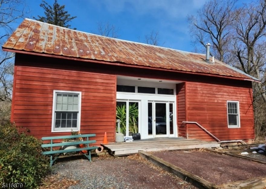 Property includes three separate structures on a total of 5.36 acres (including an adjoining 2.33-acre corner lot).The main residence is a two-story Dutch Colonial with nine rooms: five bedrooms, 2.5 bathrooms, kitchen, dining room, living room, foyer/library, and a walk-out basement.The second structure is a converted barn used as an office/carriage house with ten rooms. The walk-out first floor has three bedrooms, a living room, and a full bathroom. The second floor functions as office space with a reception area, conference room, three private offices, kitchenette, and half bath. A spiral staircase leads to a mezzanine overlooking the reception area and two additional storage rooms.The third structure is a barn offering parking, a horse stall, and storage. Stairs lead to a loft with a game room and an arts and crafts room.Utilities are separate for the main structures. The Dutch Colonial has its own electric meter and septic system, oil-fired boiler with radiators/steam heat, and propane for cooking. The converted barn/office has its own electric meter and septic system, electric heat on the first floor, radiant heat for the office level, and central air conditioning in the office area. The barn loft is heated by a ceiling-mounted propane heater.