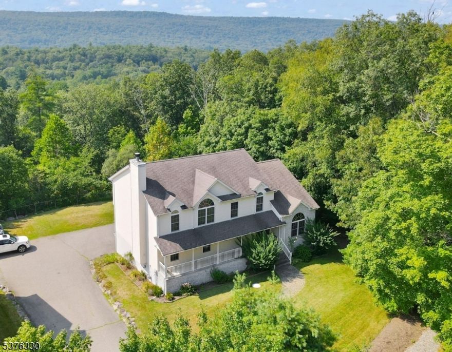 Sprawling Colonial With Expansive Living Spaces! Discover The Perfect Blend Of Comfort, Space, And Convenience! A Grand Front Porch Invites You Into A Spacious Foyer With Pristine Hardwood Floors, Flanked By A Sunlit Formal Living Room And A Sprawling Gathering Room Anchored By A Stone Fireplace, Ideal For Both Quiet Evenings And Entertaining! This Home Features A Beautifully Appointed Kitchen With Ample Cabinetry, Double Door Pantry, And A Breakfast Area With Bay Window Perfect For Taking In The Mountain Views! All Seamlessly Connects To The Formal Dining Room, Complete With Access To The Elevated Rear Deck, Where You Can Enjoy Breathtaking Sunsets And Seasonal Color Changes! This Versatile Floor Plan Includes A 1st Floor Bedroom, Laundry Room, And Powder Room, Providing Convenience And Flexibility! Upstairs, You'll Find Generously Sized Secondary Bedrooms And A Luxurious Primary Suite Enhanced Vaulted Ceilings, A Walk-In Closet, And A Spa-Inspired En-Suite With A Jetted Tub, Double Vanity, And Stall Shower! The Full, High-Ceiling Basement Is Unfinished And Perfect For Storage, Gym/Recreational Space, Or Future Expansion! A 2 Car Garage And Lower-Level Patio Complete The Rear Exterior Of This Exceptional Property! Only 6 Miles To Route 23 And 9 Miles To NY's Charming Villages, Orchards, Wineries, And Boutique Shops! This Home Offers Peaceful Suburban Living With Access To Year-Round Activities And Amenities! Schedule Your Private Showing Today!