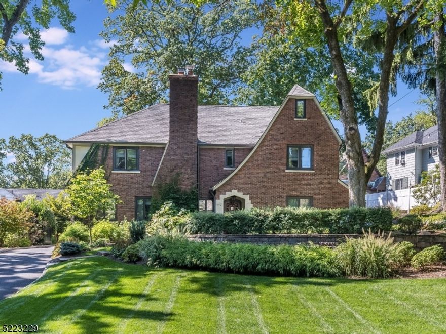 Magnificent Tudor, completely gut renovated inside & out, located in the desirable Wyoming section. Stunning 6 bedrooms and 5.5 baths on a lush, .35 acre private lot w/ impeccable craftsmanship & designer fixtures. 4 full floors of living space. First floor features an expansive family room w/wood-burning fireplace (completely reconstructed, new liner & new caps in 2018), den w/ custom built-ins, sunroom & dining room. Kitchen w/ white shaker cabinets, marble countertops w/ double waterfall island, Sub Zero 48  side by side, Wolf 6 burner range w/ custom hood, wine fridge, walk-in pantry, heated floors. Refinished hardwood floors throughout. Recessed lighting & designer light fixtures. Second floor offers primary bedroom w/ en-suite spa-like bath w/ oversized shower. Additional bedrooms & newly redone bathrooms complete this floor. Third level includes 2 more bedrooms, full bath & laundry room. Finished basement: full bath, gym, infrared sauna, movie theater, craft/art room, workshop & play space. Third car garage bay converted to office or recreation space. New plumbing & electric (2018), roof /gutters/garage doors (2018), gas boiler (steam heat/2022) gas hot water heater (2021), newer whole house water filter & water softener, newly painted. New + Newer Pella casement windows throughout. Smart Home - full security system, keyless lock, ring doorbell, nest thermostats, app garage door control. Multi zone HVAC. Generator Inlet to main panel