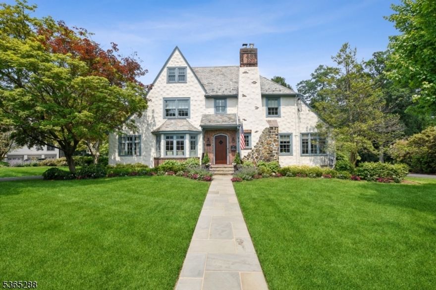 Stunning 5 Bedroom/ 5.1 Bath, designer-renovated home in Summit's prestigious Prospect Hill neighborhood. Fully reimagined Tudor with curated finishes and high-end upgrades throughout. The show-stopping kitchen features quartz counters, honed granite perimeter, Sub-Zero column refrigerators, a custom butcher block, working gas fireplace, warming drawer and hand-painted Italian marble tile. Expanded dining room with Phillip Jeffries wallpaper and window seat. Elegant powder room with brass and marble vanity. The family room includes a built-in recessed TV, wet bar, and custom window seating. Incredible primary suite with its own HVAC, walk-in closet, Steam Shower,Juliet balcony, antique mirrored fireplace, and hand-painted Chinoiserie wallpaper. Beautifully styled guest rooms on second and third floors. Additional highlights include three rebuilt gas fireplaces, three new HVAC systems, a Masterson heated pool with Lynx grill, Sonos sound system (interior + exterior), and hand-laid Italian tile in the foyer. Exceptional craftsmanship and thoughtful upgrades at every turn.