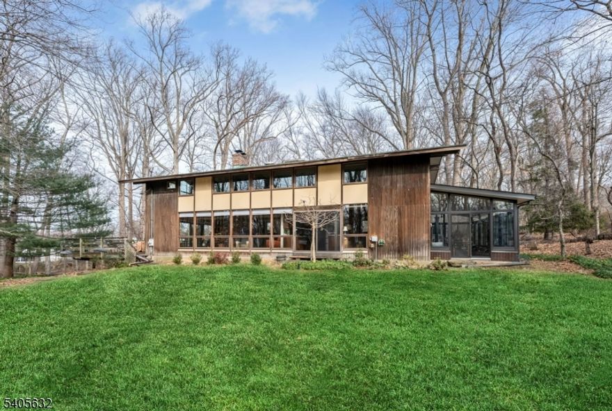 Prime East Hill location on approximately 2.25 acres, offering exceptional privacy and a serene, natural setting. Set back over 485 feet between two farms, this remarkable property feels like a private retreat while being just minutes from the GW Bridge. The sun-filled 4-bedroom, 2.5-bath contemporary chalet-style home features abundant natural light streaming through newer windows and open, flowing living spaces. The main level includes a living room with wood-burning fireplace, kitchen, dining room, family room, powder room, laundry room, and a recently rebuilt sunroom. A large deck off the living room overlooks the picturesque grounds. The second floor offers four bedrooms and two full baths, including a primary suite, along with two walk-in closets. Move-in condition with numerous updates, including newer roof, windows, air conditioning system, drainage, and underground sprinklers. Additional features include multi-zone baseboard heat, central air, and a two-car garage. Ideally located near Closter's award-winning schools, vibrant downtown, nature center, library, recreation programs, and more. A truly rare offering.