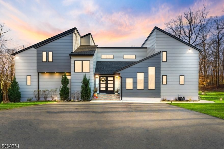 Step into luxury living with this bespoke home, renovated in 2021. As you enter, you are immediately greeted by a spacious family room, W/ natural light from the elegant Pella Casement windows. The room's grandeur is amplified by soaring ceilings and a pristine, never-used wood-burning fireplace, creating a welcoming ambiance. The open-concept lay out leads to the kitchen, where functionality meets style. A massive 10-foot quartz island serves as the centerpiece, surrounded by state-of-the-art Bertazzoni appliances, including a double refrigerator, a 36-inch gas range, a sleek microwave drawer, and an efficient exhaust hood. Custom cabinetry provides ample storage, alongside a full pantry. Effortless indoor-outdoor living is facilitated by sliding doors that open to a serene backyard. The first floor boasts two bedrooms, a full bath, and a convenient laundry room. Ascend to the second floor to discover the majestic maine bedroom, an oasis of comfort with an en-suite bathroom and dual walk-in closets. An additional bedroom, complete with its own en-suite, adds to the luxurious living experience. Delve into the finished basement, a versatile space with a roomy recreation area and dry bar and oversized garage entrance. Outdoor enthusiasts will revel in the private retreat featuring an 8 ft underground heated pool, an expansive deck, and bespoke patio furniture, perfect for entertaining or tranquil relaxation.