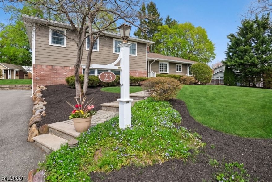 Experience the perfect harmony of modern upgrades and timeless charm at 23 Crestview Avenue, an impeccably maintained residence in a coveted Madison Hill neighborhood. Situated on a 0.3+ acre lot, this home offers four levels of finished living space, delivering a move-in ready experience with significant potential for future expansion. The heart of the home features an open-concept first floor with gleaming hardwood floors and a stunning exposed brick fireplace that serves as the architectural centerpiece for both the living room and kitchen. For those seeking a home office or creative studio, the light-filled three-season sunroom provides the ideal flex space. The upper level includes three spacious bedrooms, highlighted by a primary suite with an updated ensuite and a fully renovated hallway bathroom. Additional living areas include a bright lower-level family room with a dedicated mudroom leading to the attached 2-car garage, and a finished basement perfect for a home gym or game room.  Step out the dining room sliders to an outdoor oasis that features a large composite deck overlooking a private, expansive backyard.   Combining suburban tranquility with modern convenience, this 3-bedroom home is a premier opportunity in one of Madison's most sought-after communities.