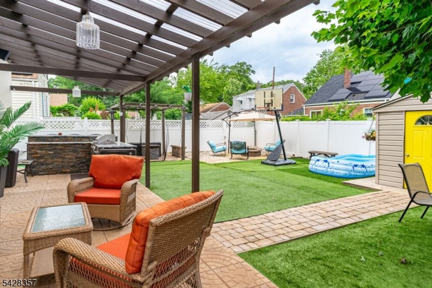 An entertainer's dream, 721 Sheridan welcomes you with three generous bedrooms, three full bathrooms and a perfect blend of indoor comfort and outdoor luxury. Step outside to discover your own private oasis, featuring a custom outdoor kitchen, a pergola-covered patio, and a cozy fire pit within a fully fenced yard. Inside, the upgrades continue with gleaming hardwood floors throughout, beautifully updated tile baths, and central air. The true cook's kitchen is ready for action, showcasing elegant stone counters, a spacious breakfast bar, and high-end appliances. The interior is bright, modern, and offers generous, light-filled bedrooms plus a finished basement for extra living space. The location is unbeatable: just steps from Warinanco Park and less than a mile from schools. Enjoy easy access to public transportation, diverse shopping, dining, and the airport. 721 Sheridan needs to be at the top of your must-see list!