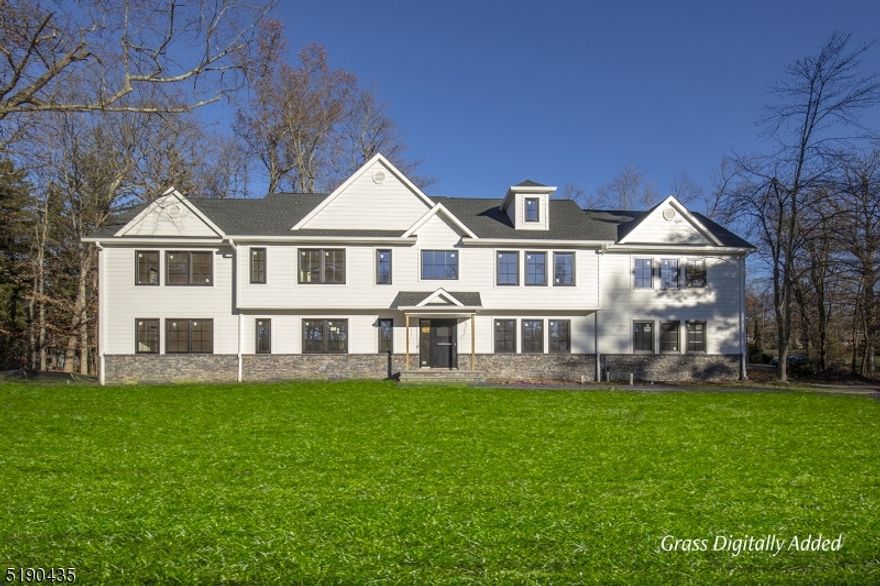 Presenting a totally reconstructed, custom-built Colonial using a modern aesthetic in one of Bergen County's most sought-after towns. Built by Fox Construction, the expansive 4,100+ square-foot layout offers five bedrooms, 4 full baths and a powder room. The home has a 2-story addition and sits on a 0.88-acre corner lot in Upper Saddle River's desirable east side. Highlights of the open floor plan include custom European DAKO windows and hardwood floors throughout the 1st and 2nd level. Introduced by a dramatic two-story foyer, main gathering spaces include spacious, sunlit living and dining rooms, and a professionally-designed kitchen containing stainless steel appliances, a roomy island, quartz countertops and a farm sink. A sliding door in the kitchen reveals the backyard patio. A home office and guest suite on the 1st level is an additional convenience. The primary suite offers 2 walk-in closets and sitting room. The primary bath has a soaking tub & frameless glass enclosed shower. Upstairs, a third en suite bedroom, two bedrooms and a full bath provide ample personal space. The 2nd story laundry room is a thoughtful amenity. An open stairway on the 2nd story leads to the finished attic, perfect as a play room.  Additional living space in the finished basement, an ideal area for casual entertaining. Finished in an appealing mix of stone and Hardiplank siding, this impressive Colonial is enhanced by a 2 car garage, 3 zones of HVAC,on-demand hot water.Grass digitally added.