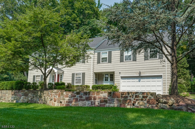 Nestled on a quiet street minutes from Short Hills train station & schools, this meticulously updated 4 bed, 3 1/2 bath center-hall colonial is the one you've been waiting for. 1st floor features oversized LR w/ wb fireplace, marble surround & built-ins, spacious formal DR, updated kitchen w/ high-end stainless appliances, quartz counters & marble subway tile open to casual dining area & oversized FR.  Stunning wood-paneled office can double as a convenient playroom, PR & access to attached 2 car garage round out 1st floor.  Upstairs offers 4 large bedrooms, 3 new baths, abundant closets & oversized laundry area.  Gleaming hw floors throughout. Newly finished bsmt provides add'l living space, recreation & exercise room. Impeccable flat fenced yard w/ playset & brick patio. A must see!