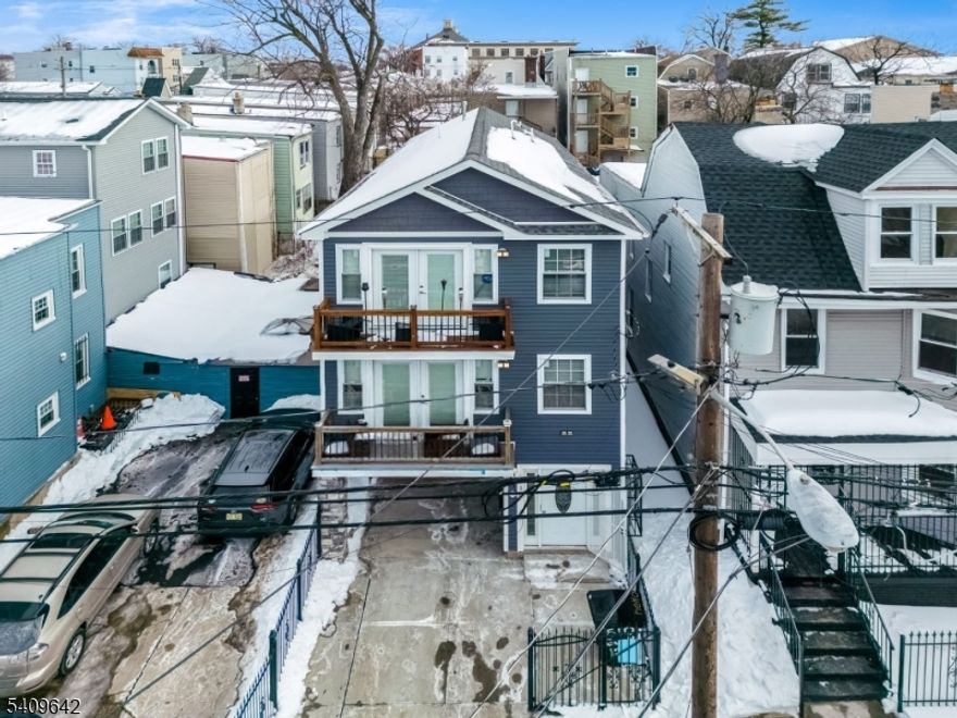 Beautiful newer-construction three-family home with modern curb appeal and parking. This striking property features a sleek blue exterior with crisp white trim, large windows, and multiple private balconies offering excellent outdoor space. Each unit offers a bright, open layout filled with natural light and contemporary finishes throughout. Unit 1 features 2 bedrooms and 1.5 baths. Unit 2 offers 3 bedrooms and 2 full baths. Unit 3 boasts 3 bedrooms and 2.5 baths, providing generous living space ideal for an owner's unit or premium rental. Enjoy the convenience of off-street parking, a covered entry, and a fenced front area for added privacy. Well-maintained and thoughtfully designed, this property is perfect for owner-occupants or investors alike. Conveniently located near transportation, shopping, and local amenities. Hurry and grab this deal asap!