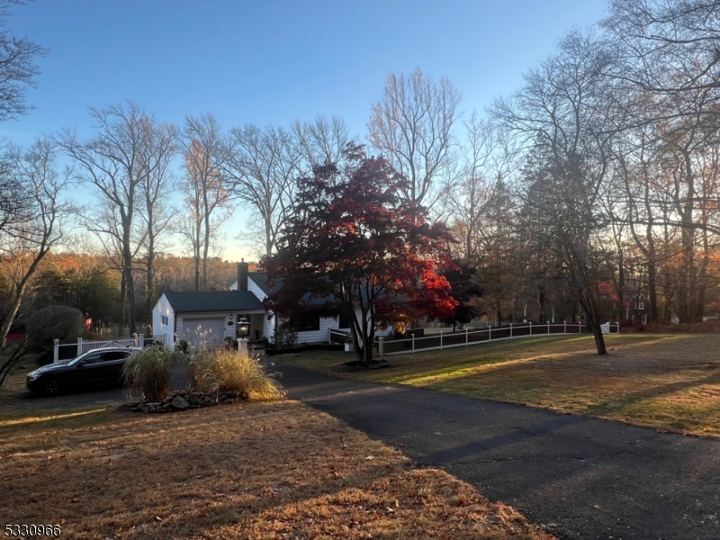 Escape to your own private retreat with this charming and unique 3-bedroom home, perfectly perched on 2 acres of tranquil grounds on the south-facing side of Mendham Mountain. This split-level gem boasts a vaulted living room, abundant closet space, and a host of thoughtful updates completed over the last four years. Upgrades include a custom wood picket fence and gates (2021), newer 4-BR septic system (2020) offering expansion potential, Anderson windows (2020), and modern appliances, including a washer, dryer, stove, and dishwasher (2024). The home also features 200-amp electrical. Step outside to the expansive backyard, where French doors open to a custom-designed entertaining space. Enjoy a generous patio, custom pool pavers, a side patio off the kitchen, beautifully crafted stone walls, aluminum pool fencing, a large storage shed, and lushly landscaped grounds brimming with mature trees. The lower level awaits your finishing touches, offering an opportunity to customize the space to your taste. The in-ground pool and A/C are not currently functioning (pool repair estimate available in the disclosure). The property is being sold as-is, presenting an opportunity to create your dream home with endless upscale potential. Located in sought-after Mendham, this home is surrounded by award-winning schools, a charming downtown area, parks, and the renowned Patriot's Path hiking & biking trails. Enjoy the convenience of NYC Midtown Direct train just minutes away in Morristown.