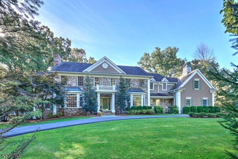 A handsome Bocina-built Bucks County Colonial with fieldstone and clapboard exterior set in one of the favorite neighborhoods in Basking Ridge has been wonderfully updated and could provide a quick closing if desired. Throughout the 5,000+ sq ft home high ceilings, wood floors and classic millwork create a gracious yet comfortable ambience in today's soft heather tones. Counter tops in most baths are exquisite leathered granite following the recent renovations. Fieldstone accents the gas fireplace wall in the sun-filled family room that overlooks the private landscaped rear grounds through a floor-to-ceiling Palladian window. An open flow of space links directly to the delightful bright kitchen and generous breakfast room, and from there to the rear patio. The living room includes a gas fireplace and French doors to a custom-built bar room, the powder room and just beyond to a window-lined office. Two staircases provide access to the second floor where flexible space includes the primary suite and its updated full bath; a loft area overlooking the family room; 2 bedrooms with ensuite baths; 2 bedrooms that share a bath; the laundry room; and a generous bonus room for work or play.The lower level is dedicated to recreation and offers a large exercise room, recreation room and a game room that flow perfectly together. A full bath and hobby/bonus room add to the well thought-out level. While the back yard is spacious, a pool can not be built close to the house.