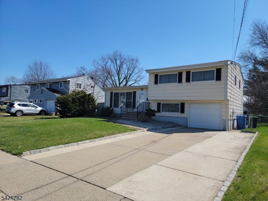 Well maintained split-level home with an attached garage located in a highly desirable neighborhood. This lovely residence features 3 bedrooms and 2 full baths. The main level includes an eat-in kitchen that leads to a formal dining room, as well as a spacious living room with high ceilings. The ground level provides a second full bath, a laundry area, and a versatile room suitable for a home office, recreation room, or guest area. Additionally, the heating, central air, and windows were all updated approximately four years ago. The property also boasts a large, private backyard that offers ample space for entertaining, outdoor activities, or relaxation.