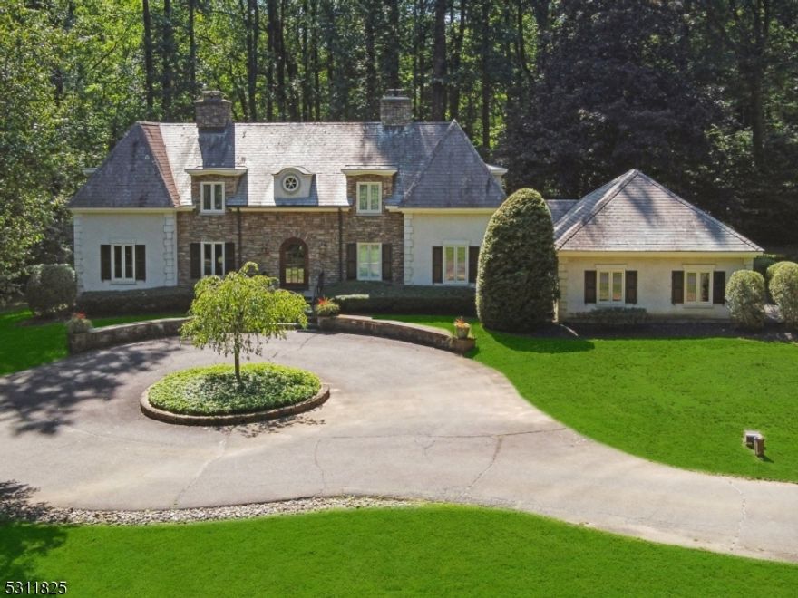 Meander down a long private driveway to this stunning 4 bedroom, 3.1-bath custom home, perfectly nestled on over 4 acres of private land in the heart of Harding. Just minutes from Morristown and Madison, and surrounded by scenic walking trails and parks, this exceptional home offers a rare blend of timeless elegance and modern comfort. From the moment you arrive, the home's stately curb appeal captivates. Step into the front to back foyer, where natural light pours in, highlighting the impeccable craftsmanship throughout. The large eat-in kitchen with a mudroom flows into the grand dining room, complete with a fireplace, perfect for intimate gatherings. The richly paneled family room, features a wall of bookcases, a cozy fireplace, and breathtaking views from every angle. The living room, also with a fireplace, leads to a charming sunroom with a slate floor and direct access to a large bluestone patio an idyllic space to enjoy the outdoors. Upstairs, the second level features four well appointed bedrooms and three full baths, including the luxurious primary suite, a private oasis with fireplace,spa-like bath, an expansive walk-in closet, and a dedicated office. The sprawling lawn offers plenty of room for play and gardening, creating a serene retreat. This home boasts a newer furnace, hot water heater, HVAC, and a whole-house generator, ensuring comfort and peace of mind. A rare opportunity to own a private sanctuary in one of Harding's most coveted locations.