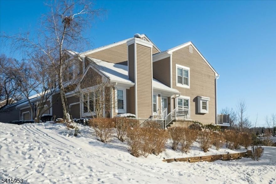 This sun-drenched end-unit townhouse in the desirable Stone Edge section of The Hills in Bedminster is perfectly situated on a quiet cul-de-sac with scenic views. As you approach the home, beautiful landscaping and a welcoming entry set the tone for this thoughtfully maintained residence. Inside, the home offers three bedrooms, three full bathrooms, and one half bath, with a spacious layout designed for comfortable everyday living and entertaining. You are greeted by an open-concept living and dining area with soaring lofted ceilings and a cozy fireplace, creating a warm and inviting atmosphere filled with natural light throughout the day. The kitchen features an eat-in island, pantry, and direct access to a private deck, where you can relax while enjoying stunning, peaceful views. Upstairs, the primary ensuite provides a serene retreat with a walk-in closet, double sinks, and a luxurious soaking tub. One of the home's standout features is the walkout basement with a full bathroom, offering flexible space ideal for long-term guests, recreation, or entertaining. This home is truly move-in ready, with recently updated utilities, including a newer furnace and newer AC units. Residents also enjoy the convenience of an attached garage along with access to community amenities, including a clubhouse, pool, and tennis courts. With its abundant natural light, thoughtful flow, private outdoor spaces, and sought-after location, this home offers an exceptional lifestyle in The Hills.