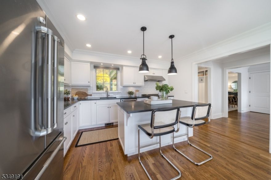 BEAUTIFUL COLONIAL ON LUSH 1-ACRE LOT WITH INCREDIBLE OPPORTUNITY TO EXPAND! Create the casita-style compound/entertaining space of your dreams complete w/ Golf Simulator, Gym, Office, and Bath  using amazing plans already approved by town. Main house is a gorgeous Colonial (rebuilt 2013) that masterfully combines modern comfort and timeless elegance. Bright and inviting w/ hardwood floors, stylish new light fixtures and wood-burning fireplace w/ stunning shiplap accent wall in Family Room. Cheery Eat-In Kitchen with s/s appliances, white wood cabinetry, Dry Bar w/ beverage fridge, tremendous light. First Level also has a Home Office, In-Law Suite w/ Full Bath, and access to the Paver Patio from Mudroom and Dining Room for easy indoor/outdoor living. Second Level has 3 bright Bedrooms w/ Custom Closets and Full Hall Bath w/ double sinks, bead board, crisp subway tile. The 4th large Primary Bedroom has great storage (2 Custom Closets, 2 additional Storage Closets), tray ceiling, and lots of light. En-Suite Bath w/ glass door shower, separate soaking tub, and double sinks. Lower Level with Rec Room, Storage Room, Mudroom w/ Garage Access and new carpeting. Park-like, sprawling property on cul-de-sac w/ breathtaking views, mature trees, stone walls. Surrounded by protected land for added privacy. Great location near 2 NYC-direct trains and proximity to shops, restaurants. Top-rated Chatham public schools. Write your own story at this truly special home with endless opportunity!