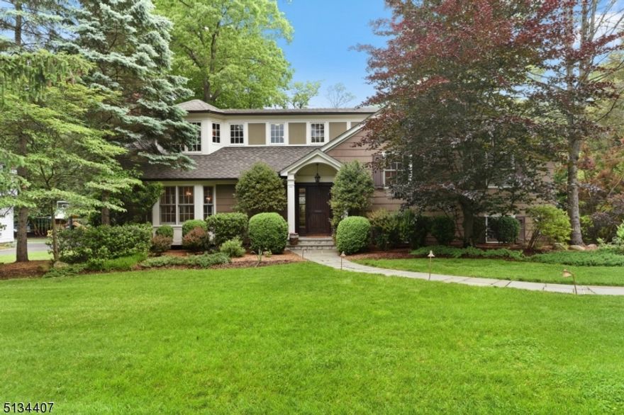 A spectacular home designed by the premier firm WESKetch Architecture + Construction. Located in the sought-after Poet's section in the Hartshorn school district, this 5 BR, 3.2 bath custom home w/outstanding architectural details & floor plan is perfect for entertaining & every day living. Elegant 3-story entrance w/ beautiful millwork sets the stage for this gracious home. Sun-filled LR with bay window, gas FP & custom bookcases is open concept to a formal DR & Family Rm. The spacious DR has detailed millwork, coffered ceiling, graceful columns & large windows. Flow continues to the Family Rm & gourmet Kitchen. Family Rm boasts magnificent stone FP, tray ceiling, walls of windows & French doors which lead to a covered deck. Gourmet kitchen has plenty of custom wood cabinetry for storage, under cabinet lighting, granite counters, center island, peninsula breakfast bar, SS appliances w/eat-in dining area, surrounded by windows & French doors to the outside deck. Second floor includes 3 large BRs and 2 full bathrooms, one en suite. The stunning primary BR suite on the 3rd fl has 2 large walk-in closets w/ built-ins, & MB with a 2 sink vanity & an oversized shower. The ground level has a guest bedroom & half bath, w/access to the backyard & garage. Basement provides endless space for entertaining/play w/ stone bar, 3 generous sized rms, lots of closets for storage, & Laundry Rm. The outside covered deck & dining area overlook the large level yard w/room for a pool.