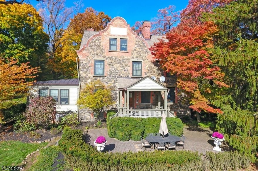 Historic Short Hills living at its finest! This beautifully updated and expanded original Hartshorn residence features an expansive layout, breathtaking interiors, and lush park-like grounds. Inside the sun-drenched showplace, you'll find hardwood floors, graceful millwork, ALL new windows, and period glass doors throughout. An original Dutch farmhouse door welcomes you into a large living room flanked w two fireplaces, while the adjacent  expansive family room boasts vaulted cedar ceilings, a rustic stone feature wall and exposures on three sides. Enjoy a gracious formal dining room, convenient butler's pantry and spectacular contemporary kitchen with custom cabinetry, quartzite counters and high end appliances. A large breakfast room, study, two mudrooms and a new powder room complete the main level. Ascend the stunning staircase to discover the sprawling owner's suite featuring a bright sitting room with a fireplace, a separate bedchamber, exceptional custom closet space and a marble bath. Two secondary bedrooms with fireplaces share a lovely hall bathroom on the second floor, while the top floor offers three more bedrooms and a windowed bath. The lower level delivers a massive footprint for recreation, storage, exercise or and/or media, plus a full bath and laundry room. Magnificent, lush 1.14 acre lot w covered porch, large patio, rolling lawns and towering trees. Outstanding Old Short Hills location close to amenities, schools and the train station.