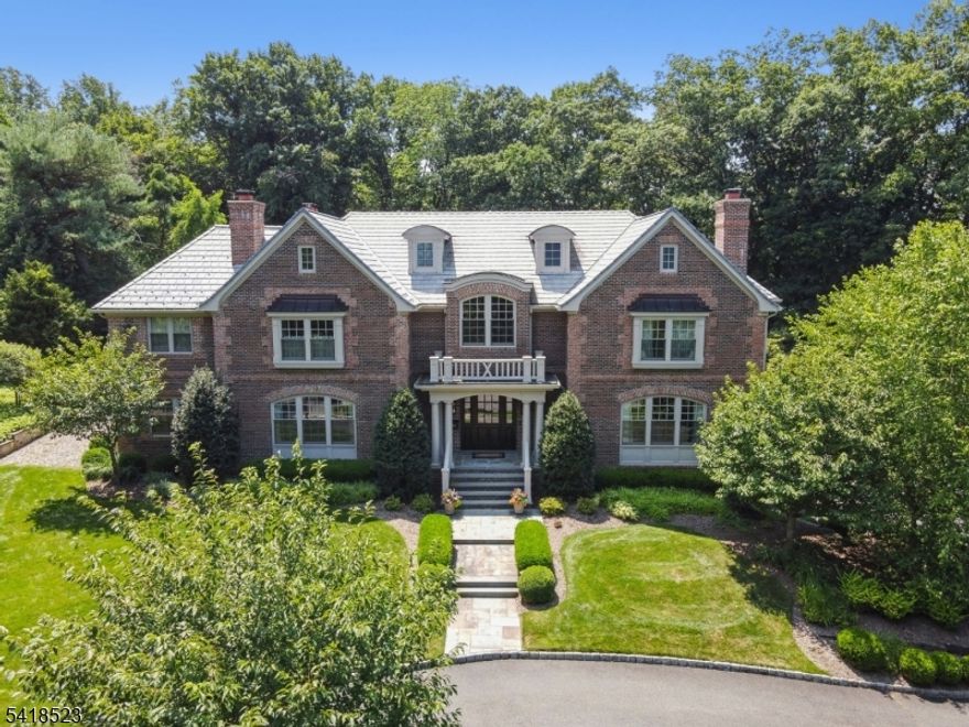 Experience the pinnacle of luxury living in this magnificent, stately 9,000 sq ft All Brick Colonial w/ Davinci Slate roof on .88 acres of gorgeous property w/heated saltwater pool! Designed by Dubinett Architects & built by Moore Developments in 2013, this 7 bedroom, 7.2 bath home is a true showcase of timeless elegance, superior craftsmanship, and bespoke design. Circular drive leads to grand 2-story EH, living room w/ wood burning FP w/gas starter flanked by bookcases, & dining room perfect for entertaining w/butler's pantry & 1000 bottle wine cellar. The heart of the home is a stunning gourmet eat-in kitchen w/crisp white custom cabinetry, marble center island, 2 walk-in pantries, Subzero 36" refrigerator/freezer, Wolf range & 2 Bosch DWs totally open to family room w/ coffered ceiling & wood burning FP w/ gas starter, 2 sets of French doors from family room & set of French doors from kitchen open to expansive Bluestone patio & saltwater pool. 1st level in-law suite, office w/ custom built-ins & "pool house" full bath open to bluestone patio. On 2nd level there is a luxurious primary suite w/sitting room, gas FP, 2 custom WICs & balcony overlooking property. Spa-like primary bath w/jacuzzi & steam. 4 more bedrooms & 3 more baths & laundry. Radiant heated floors in all baths. Lower Level has rec rm, home theater, exercise room/bedroom suite, mudroom, 3-car heated garage. Elevator-ready shaft. Walking distance to Pingry Lower School, Hartshorn Elementary School & Gero Park.