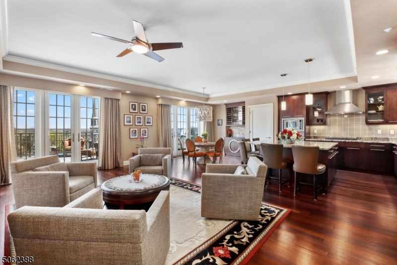 Luxury in the heart of Morristown, this Penthouse is in one of the area's premier locations with 2716 sq. ft. of living space and a large outdoor terrace overlooking the Historical Morristown Green. Unique Penthouse with exceptional details. 2 bedroom, 3 full bath unit has an open floor plan with beautiful panoramic views of the Morristown Green. 3 sets of French doors lead to the oversized terrace with built-in gas grill. Custom wet bar in the formal living room and hidden pantry in the kitchen. Spacious dining room, kitchen and living room combination, with a gourmet kitchen with 5-seat center island, custom walk-in pantry, Viking appliances. Library/office has built-in shelving and a Juliette balcony. Large main bedroom with 2 walk-in closets, ensuite elegant bath. Urban oasis in the center of town.