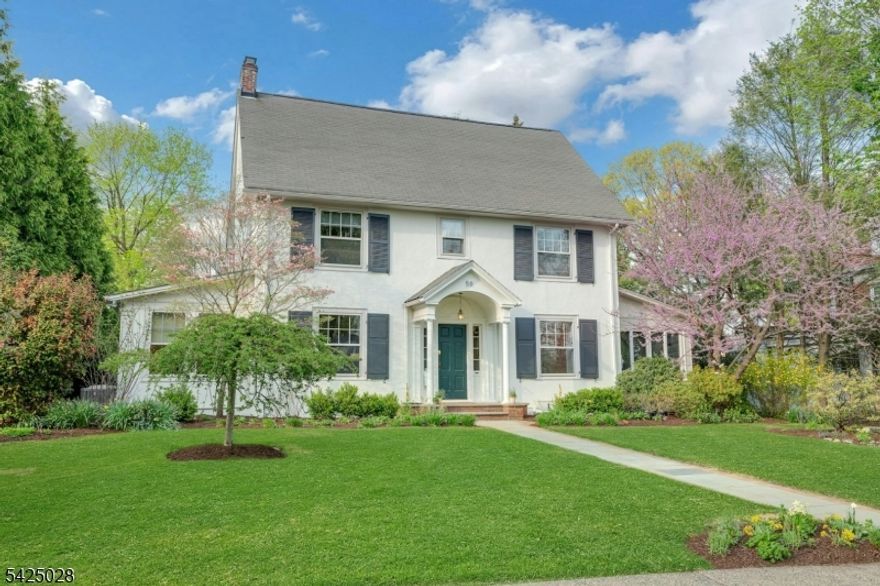 Picture-perfect center hall Colonial on a quiet, tree-lined block just two blocks from the train and close to Upper Montclair village, an exceptional opportunity not to be missed. Set on a rare .39-acre lot, this beautifully maintained and move-in ready home offers the perfect blend of timeless character, generous space, and unbeatable convenience. Sun-filled and inviting, the home features high ceilings, hardwood floors, original moldings, original doors and hardware, and two fireplaces. The updated kitchen, with delightful morning light and stainless-steel appliances including Sub-Zero, opens to a stunning great room addition with built-in bar, wine refrigerator, fireplace, and huge glass doors overlooking the patio and expansive private backyard. A formal dining room, large living room, two sunrooms, and finished basement provide exceptional space for everyday living, entertaining, work-from-home, and play. Freshly painted inside and out, with central A/C, whole-house generator, newer water heater, resealed driveway, and detached two-car garage, this home offers year-round comfort and peace of mind. Spanning four finished levels, it includes 5 bedrooms, 3 full baths, and 2 half baths. The backyard is professionally landscaped with mature trees, flowering gardens, and room for a swing set, pool, and sports court all at once. With both local and express trains nearby, Manhattan is just 45 minutes by train or approximately 30 minutes by car or bus.