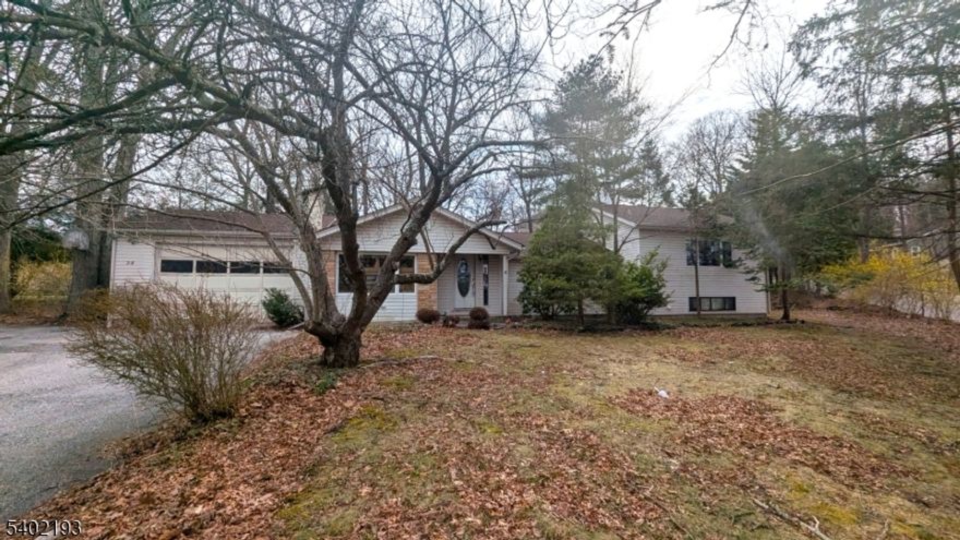 Located in the desirable Deer Trail Lake community, this light-filled 3-4 bedroom home offers flexible living space and year-round enjoyment. Two bedrooms are currently open to one another and could easily be converted to a legal 4th bedroom with the addition of a wall, closet, and door. The primary bedroom features its own private bath. A beautiful bay window and multiple skylights in the kitchen, bathroom, guest bedroom, and primary bath bring in abundant natural light throughout. Cozy up by the propane fireplace or unwind in the unique greenhouse-style spa room complete with jacuzzi and sauna. Additional highlights include a finished daylight walk-out basement, finished walk-up attic, sliders from the kitchen to the backyard, an oversized 2-car garage, and a shed with loft for extra storage. Optional lake membership offers swimming, fishing, and kayaking in a peaceful setting. Convenient to Route 23 and Route 94, approximately 10-15 minutes to Mountain Creek skiing and waterpark, 30 minutes to the Delaware Water Gap, and about 1 hour to NYC. Close to shopping, dining, golf, and year-round recreation. Property is being sold strictly as-is. Buyer responsible for any town/state certifications required to close.