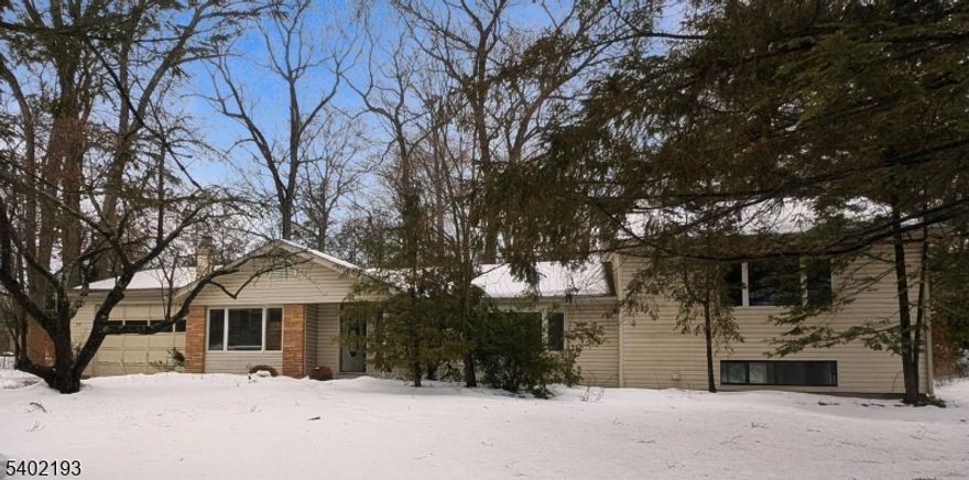 Located in the desirable Deer Trail Lake community, this light-filled 3-4 bedroom home offers flexible living space and year-round enjoyment. Two bedrooms are currently open to one another and could easily be converted to a legal 4th bedroom with the addition of a wall, closet, and door. The primary bedroom features its own private bath. A beautiful bay window and multiple skylights in the kitchen, bathroom, guest bedroom, and primary bath bring in abundant natural light throughout. Cozy up by the propane fireplace or unwind in the unique greenhouse-style spa room complete with jacuzzi and sauna. Additional highlights include a finished daylight walk-out basement, finished walk-up attic, sliders from the kitchen to the backyard, an oversized 2-car garage, and a shed with loft for extra storage. Optional lake membership offers swimming, fishing, and kayaking in a peaceful setting. Convenient to Route 23 and Route 94, approximately 10-15 minutes to Mountain Creek skiing and waterpark, 30 minutes to the Delaware Water Gap, and about 1 hour to NYC. Close to shopping, dining, golf, and year-round recreation. Property is being sold strictly as-is. Buyer responsible for any town/state certifications required to close.