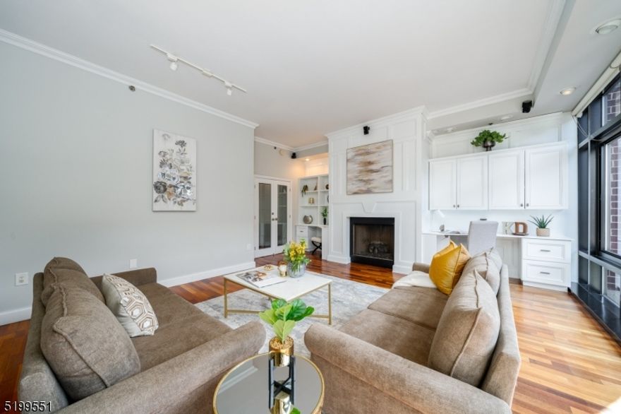 One of a kind Sky Club luxury duplex offers engaging floor plan & striking interiors. 3880 SF of gorgeous living space stretch over 5 beds, 4 baths, den, & 4 private outdoor spaces! 1 year of garage parking included. 1st floor features open living space w/ 10 ft ceilings & glass stairwell. Kitchen offers SS appliances, dish washer & center island w/ beverage fridge. Dining area encompasses a granite kitchenette, wine fridge, & large pantry, leading out to the balcony. Enjoy entertaining guests in your oversized living area complete w/ fireplace, custom built-ins, & immense natural sunlight. Enter into the first of the 2 large primary suites w/ 2 cedar walk in closets & another balcony. Ensuite bath with spacious shower, vanity area, heated floors & more. The stairway leads you to the 2nd floor where you will find an additional 4 beds, den, 2 baths, 2 balconies, washer/dryer room & kitchenette. The 2nd suite has decorative ceiling & fireplace w/ a balcony off the room. Be wowed by the gorgeous custom designed dressing room & a huge ensuite bathroom with jacuzzi tub, shower, double sinks & heated floors. Additional features in this home are: Hardwood floors, recess lighting throughout every room, floor to ceiling windows, custom closets/ built ins, Hunter Douglas shades, & tons of storage. The Sky Club features 24 hour concierge, shuttle to/from path, community room & bike storage. Near light rail, restaurants, shops, parks, schools and more.