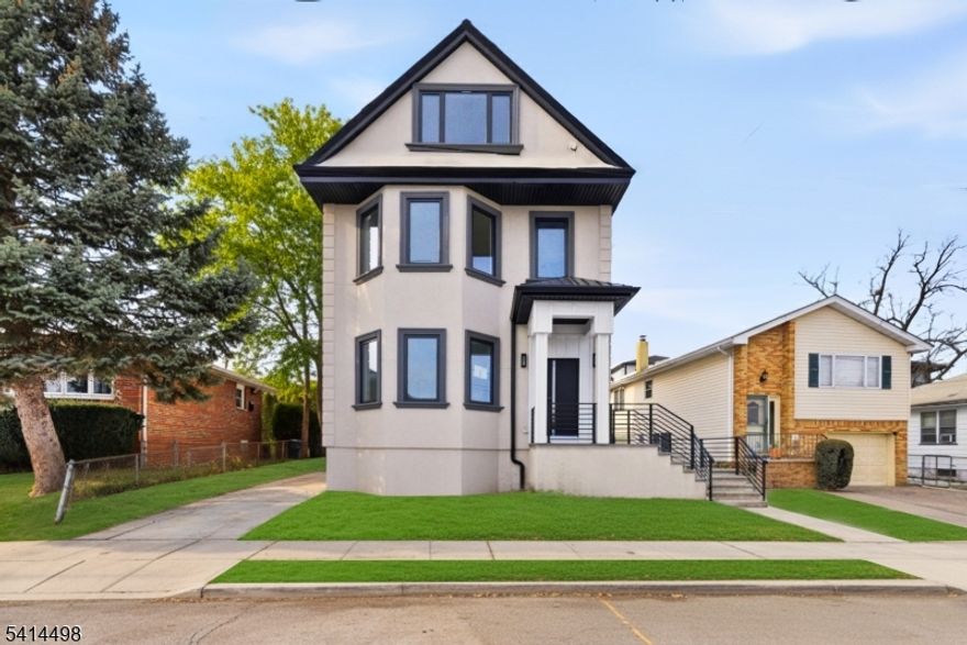 Fully Renovated 8 Bedroom and 5 Bathroom Home with In-Law Suite & Walk-Out Basement Modern Finishes Throughout. This newly renovated home offers exceptional space, versatility, and high-end finishes throughout. Featuring 8 bedrooms and 5 full bathrooms, the property is designed for flexible living with thoughtful upgrades including premium tile work, modern vanities, and quality materials across every level. The main living areas provide bright, open spaces with a large kitchen that flows directly to a private patio through sliding doors, perfect for outdoor dining and entertaining. Central air conditioning with separate systems by floor ensures year-round comfort. A standout feature is the fully finished walk-out basement, configured as an in-law suite. This level includes two bedrooms, a full kitchen with appliances, living room, and full bathroom, with direct access to the driveway ideal for guests, or additional flexibility. All kitchen appliances are included, along with a wine cooler and full basement kitchen appliances. Washer and dryer hookups are present. The driveway provides parking for multiple vehicles. Conveniently located near local shopping, restaurants, and everyday amenities, this move-in-ready home offers rare size, modern finishes, and multi-level living potential.