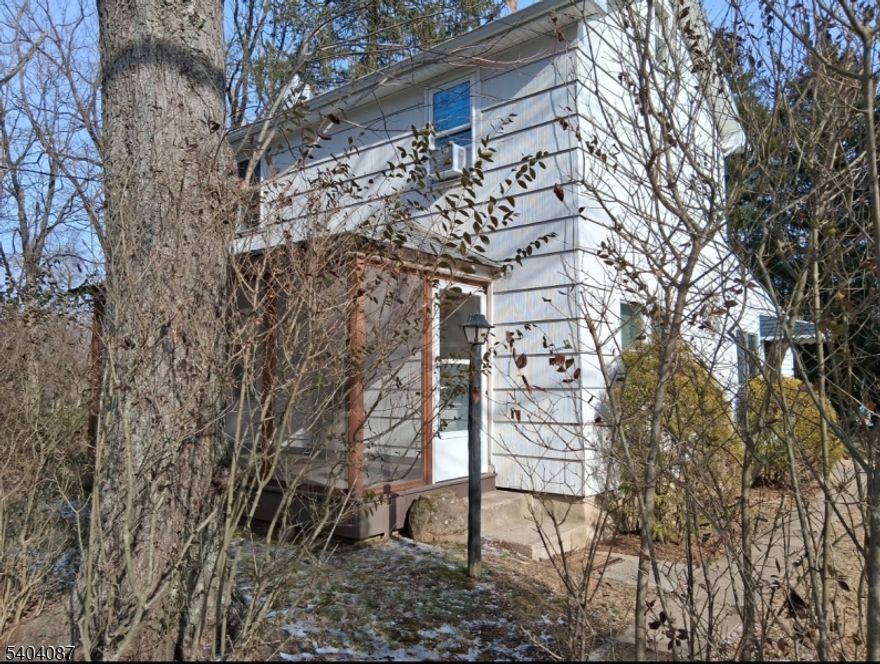 Timeless charm meets tranquil views.  Welcome to 223 Goat Hill Road, a beautifully preserved 1908 home offering classic character and peaceful surroundings.  This 2 bedroom, 1 full bath residence features original hardwood floors, a sun-filled enclosed porch, and stunning views backing up to 21 aces of preserved land and mature trees.  Perfect for those who appreciate history, privacy, and nature-yet still want convenience as it's walking distance to downtown Lambertville.  This one will not last.