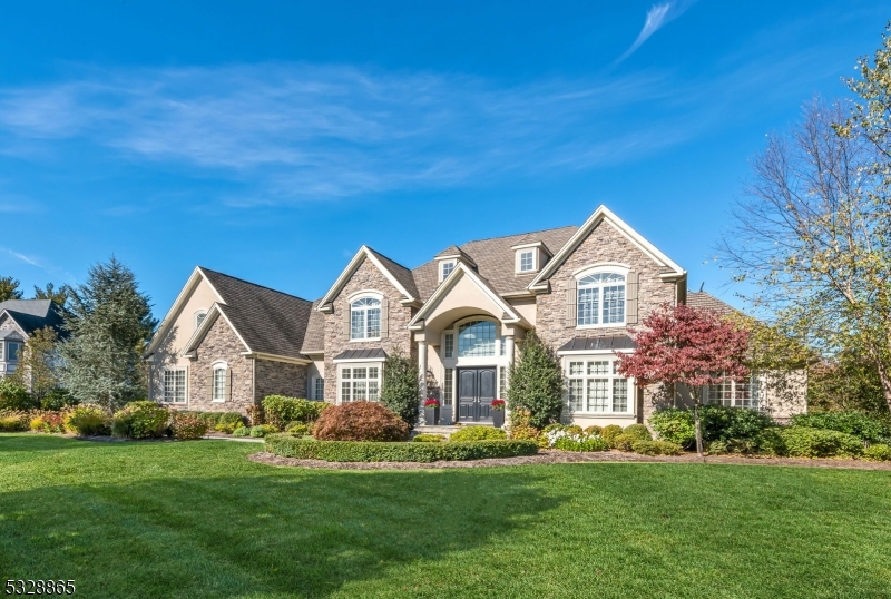 Welcome to 12 Harvest Way, Denville, NJ   a blend of modern elegance and timeless luxury. This 5-bedroom, 5-full and 2-half bath estate offers over 6,000 sq ft of refined living space.  The main level boasts an eat-in kitchen with top-tier appliances, formal dining room, spacious living room with fireplace, private office, half bath, laundry room, and a first-floor bedroom suite.  Upstairs, find four large bedrooms, including a primary suite with a double-sided fireplace, spa-like bath, and 2 large walk-in closets. A second laundry room adds convenience.  The finished basement is perfect for entertaining with a custom bar, wine wall, recreation space, gym, and sauna.  The backyard offers resort-style living with multiple seating areas, fireplace lounge, built-in grill, custom pool, and a pool house with a kitchen, bath, and automatic door for year-round use.  12 Harvest Way is more than a home   it's a lifestyle of modern luxury and elegance.