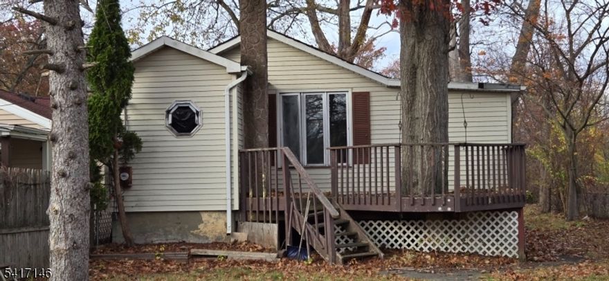 Cozy 2 br home.  Needs work but has strong potential. Enjoy the country setting on either the front or back decks but be only minutes from Rts. 46, 80, 23, 3, Willowbrook Mall & NJ Transit parking or buses, Little Falls Train for NY commuters.   2 car over-sized detached garage. Close to schools, churches, transportation and shopping.  House is set back from the street so even your front yard is private. Cash or renovation loans only. Will not pass conventional or FHA.