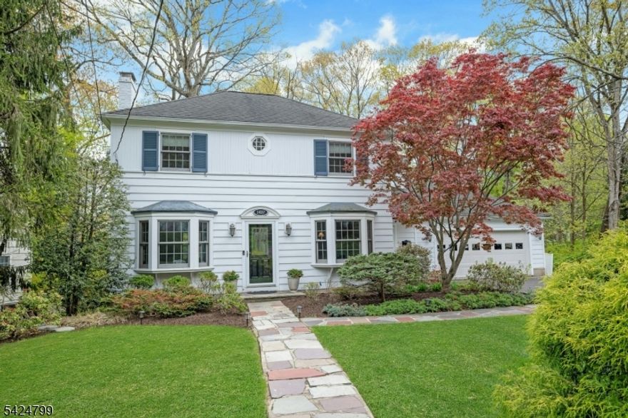 Charming Colonial set on a beautiful Mountainside street, blending classic character with thoughtful updates. Situated on a .38 acre lot, the home offers a warm, inviting layout with hardwood floors throughout. The main level features a bright living room with a wood burning fireplace, a formal dining room and an eat-in kitchen that open to a spacious family room. Large windows bring in natural light and offer peaceful views of the backyard. A convenient side entrance leads to a mudroom off the 2 car garage. Upstairs four bedrooms include a primary suite with a walk-in closet and full bath. Located close to NYC for commuting options, major highways and Newark Airport. This home offers comfort and convenience in a sought-after setting.