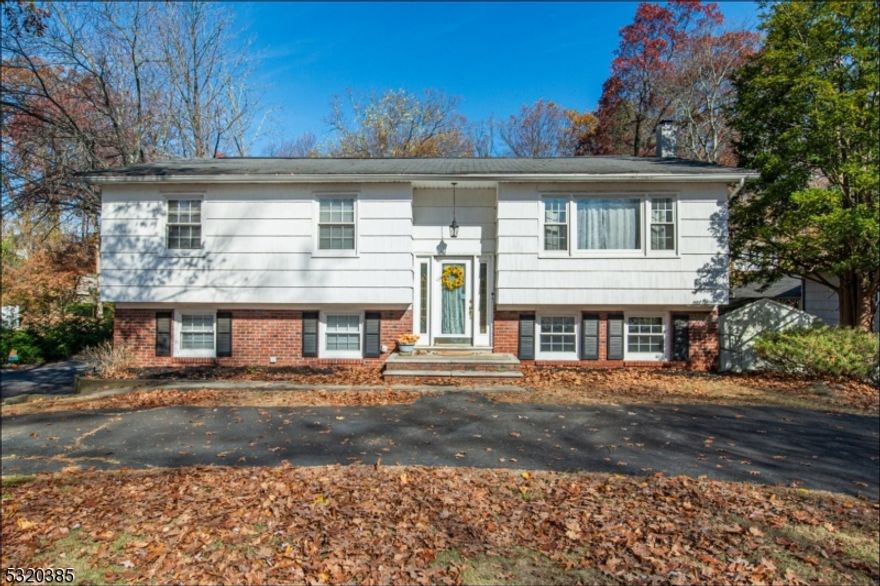 Lovely three bedroom, two and half bath Bi-level in a quiet, desirable neighborhood of Landing.  Great opportunity to own this huge lot, (100 x 150). Possible Mother/Daughter, wonderful wrap around driveway that can accommodate six cars for when entertaining guests, glistening hardwood flooring, formal dining room with large double sliders that lead to an amazing deck for celebrations and festivities, large eat in kitchen, plenty of kitchen cabinets, stainless steel appliances, master bedroom with renovated master bath, two additional bedrooms with plenty of natural lighting, freshly painted with light colors, immaculate, massive family room or wreck room, great for the holidays, cuddle up on the couch by the crackling fireplace with a book, cup of hot chocolate & a blanket on those cold wintery nights, tremendous backyard big enough to host that Thanksgiving football game or big enough to install an underground swimming pool, patio, oversized two car garage, laundry room, convenient playground down the street & minutes to the local beach.   Easy access to all major routes like 80, 46, 10, shopping, restaurants, close by, low taxes & possibly join the beach club!