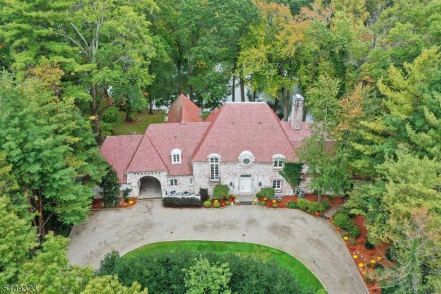 Majestic Brick South Facing, so gets great natural light, FRENCH MANOR ESTATE ideally located in most coveted location on prestigious North Pond in most desirable location  in Short Hills. Present owner totally reconfigured home, now has open floor plan, you will love the spectacular water views from almost every room from floor to ceiling French doors including 1st floor living room, dining room, sunroom, family room, and stunning new gourmet kitchen in 2023 with designer cabinets, high end Stainless Steel appliances, center island, custom copper hood over range and hammered copper sink. Circular driveway and elegant double doors lead into grand hallway with elegant circular staircase. Second floor boasts a luxurious Primary Suite with stunning new bath (2023), and custom walk in closets. Additional 4 bedrooms, study area and three baths plus convenient laundry are on the second floor. Large walkout basement includes finished recreation room and additional bedroom and bath, ideal nanny suite. Spectacular, private backyard oasis and multiple stone patios complete this stately residence. Do not miss this RARE opportunity to own this regal residence! Now has new Gourmet Kitchen, baths and thermal windows!