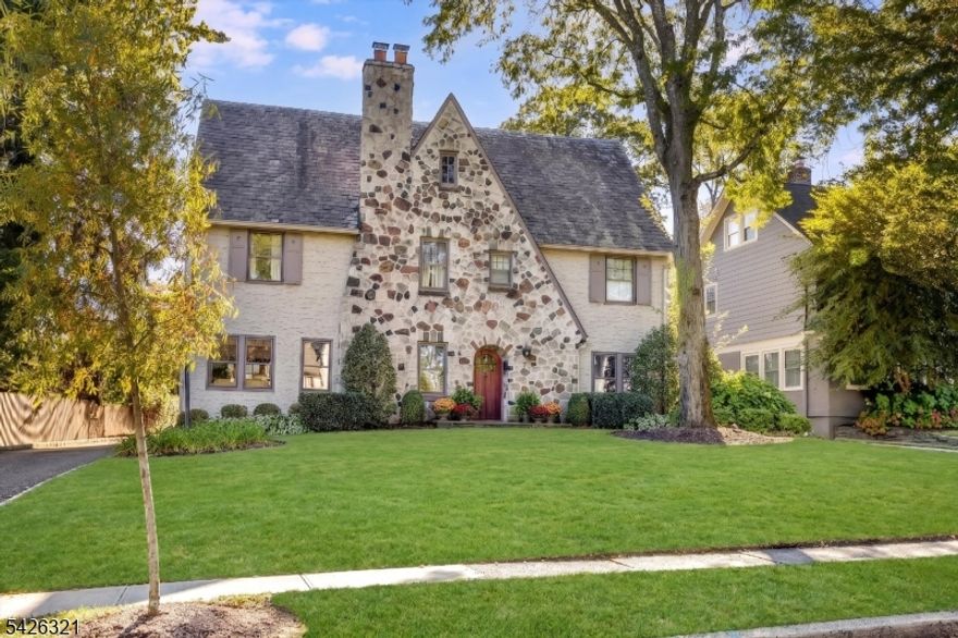 Refined, polished, and perfectly poised, this home is a true jewel in the desirable north end of Glen Ridge. It is a beautifully curated environment where inspired craftsmanship and period details meet a very genuine sense of home. The main level is defined by a particular kind of grace, featuring a living room with a wood-burning stone fireplace, rich chestnut accents, and gleaming hardwood floors that continue into a formal dining room made for warm evenings and easy hosting. A sunroom off the living room extends the living space and opens onto the patio just like the kitchen, which features high-end appliances and cabinetry. This dual access creates a seamless connection to the lush, private backyard, a secluded sanctuary surrounded by mature, privacy-inducing plantings. Upstairs, the second floor serves as a sanctuary of its own, with three spacious bedrooms including a stunning primary suite and dressing room. The third floor offers two additional bedrooms and a truly delightful surprise: a sprawling family room with a soaring cathedral ceiling that provides an unexpected sense of light and air. With a finished basement recreation room and ample storage throughout, this home offers the rare balance of generous proportions and a warm, inviting atmosphere. Perfectly located near the Glen Ridge Country Club, the highly-rated Forest Avenue School, and the Jitney to the train station, this is a permanent piece of Glen Ridge charm designed for a lifetime of memories.
